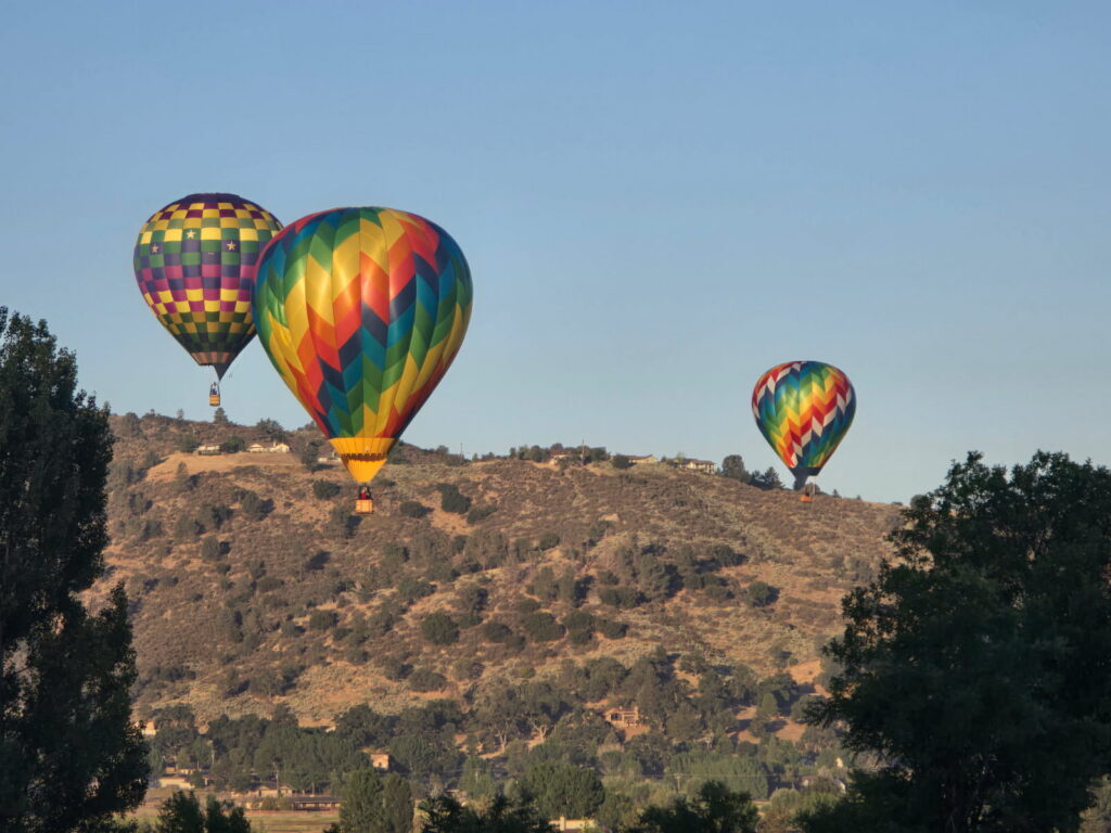 Hot air balloons rising over the oak-covered hills of Bear Valley Springs